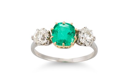 Lot 307 - An EMERALD AND DIAMOND THREE STONE RING, the...