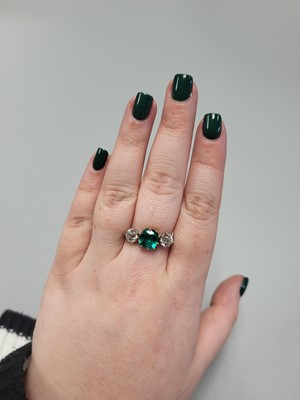 Lot 307 - An EMERALD AND DIAMOND THREE STONE RING, the...