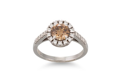 Lot 133 - A COGNAC AND WHITE DIAMOND CLUSTER RING, of...