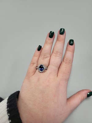 Lot 134 - A SAPPHIRE AND DIAMOND RING, the oval sapphire...