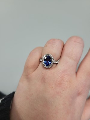 Lot 134 - A SAPPHIRE AND DIAMOND RING, the oval sapphire...