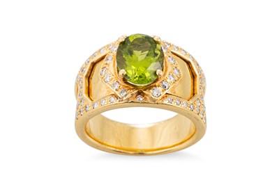 Lot 205 - A PERIDOT AND DIAMOND RING, the oval peridot...