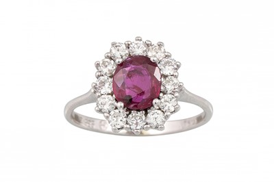 Lot 308 - A RUBY AND DIAMOND CLUSTER RING, the oval ruby...