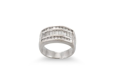 Lot 250 - A DIAMOND THREED ROWED RING, the channel set...