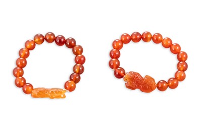Lot 511 - A PAIR OF CARVED CARNELIAN BEADED BRACELETS,...