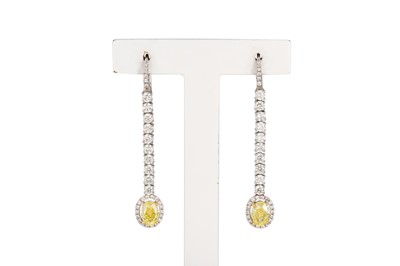 Lot 311 - A PAIR OF FANCY INTENSE YELLOW & WHITE DIAMOND...