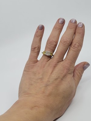 Lot 312 - A FANCY VIVID YELLOW AND WHITE DIAMOND THREE...