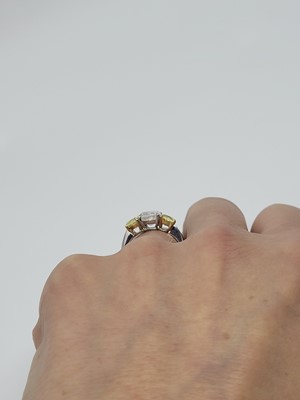 Lot 312 - A FANCY VIVID YELLOW AND WHITE DIAMOND THREE...