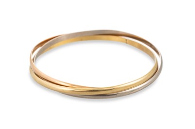 Lot 365 - A CARTIER TRINITY TRI-COLOUR BANGLE, set with...