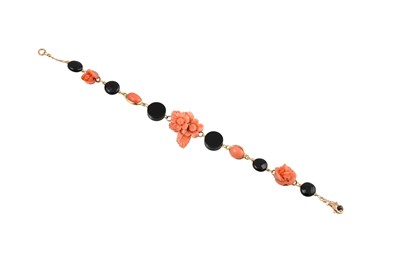 Lot 352 - A CORAL AND ONYX BRACELET, the coral floral...