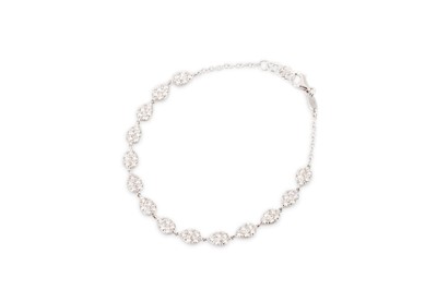 Lot 219 - A DIAMOND SET CLUSTER BRACELET, the teardrop...