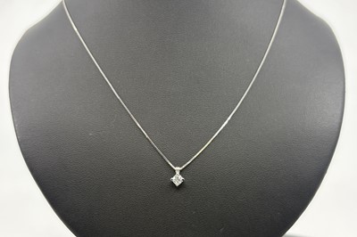 A DIAMOND SINGLE STONE PENDANT, the round...