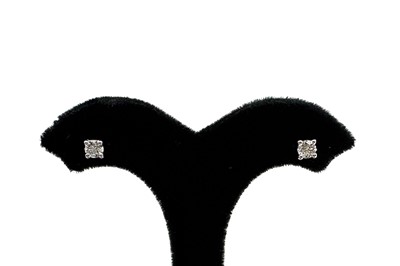 A PAIR OF DIAMOND STUD EARRINGS, the round...