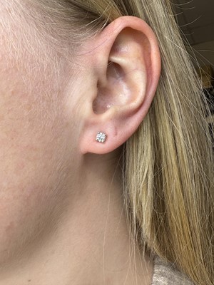 A PAIR OF DIAMOND STUD EARRINGS, the round...