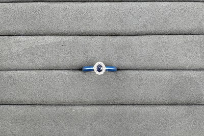 AN ENAMEL, SAPPHIRE AND DIAMOND RING, the oval...
