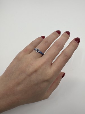 AN ENAMEL, SAPPHIRE AND DIAMOND RING, the oval...