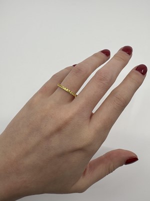 A YELLOW SAPPHIRE FULL ETERNITY RING, the...