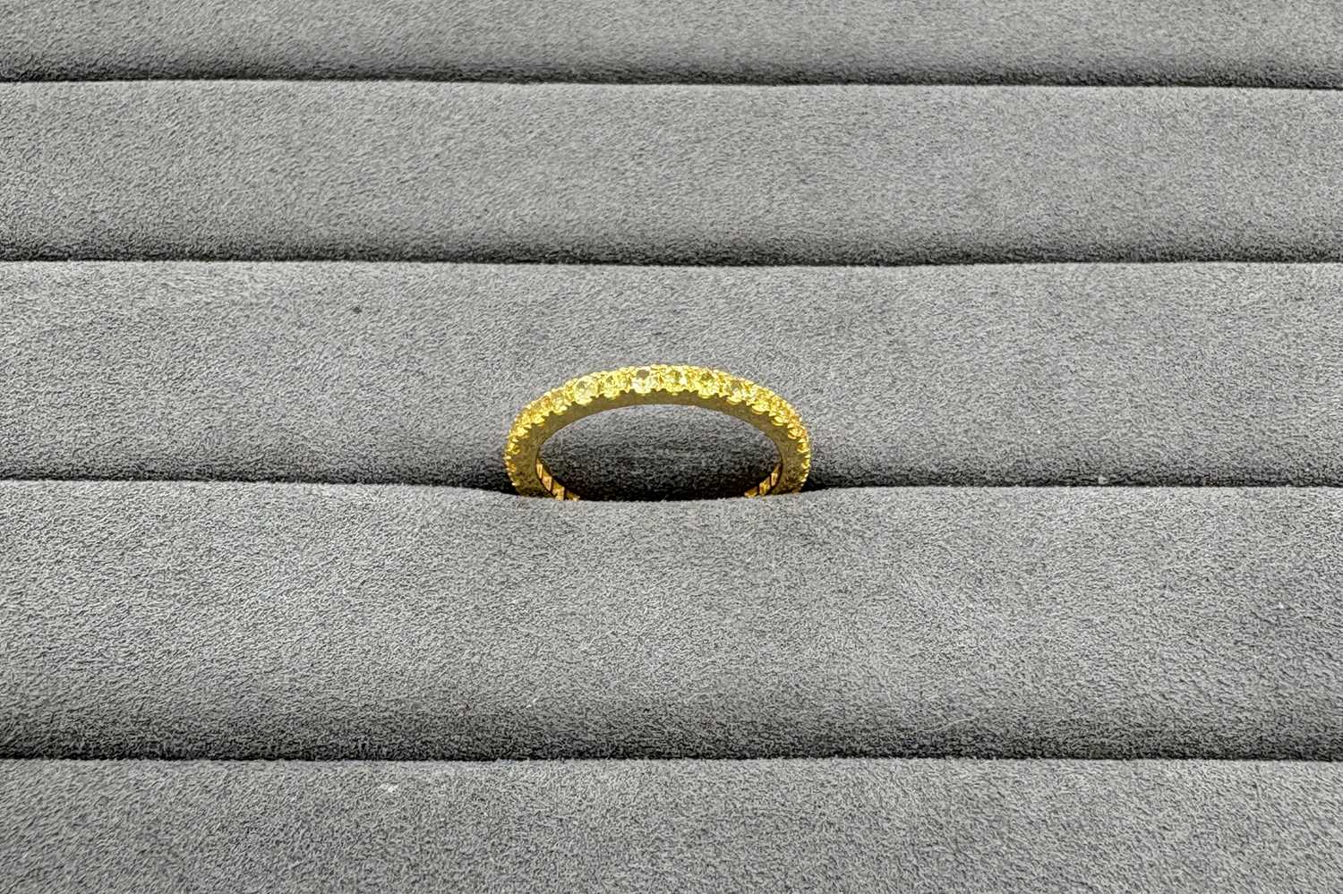 A YELLOW SAPPHIRE FULL ETERNITY RING, the...