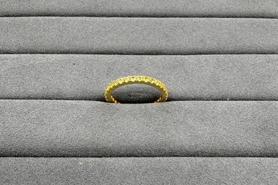 A YELLOW SAPPHIRE FULL ETERNITY RING, the...