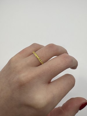 A YELLOW SAPPHIRE FULL ETERNITY RING, the...