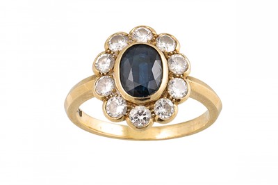 Lot 383 - A DIAMOND AND SAPPHIRE CLUSTER RING, the oval...