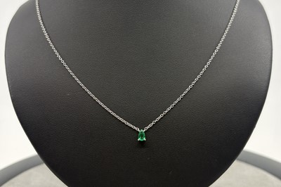 AN EMERALD SINGLE STONE PENDANT, the pear cut...