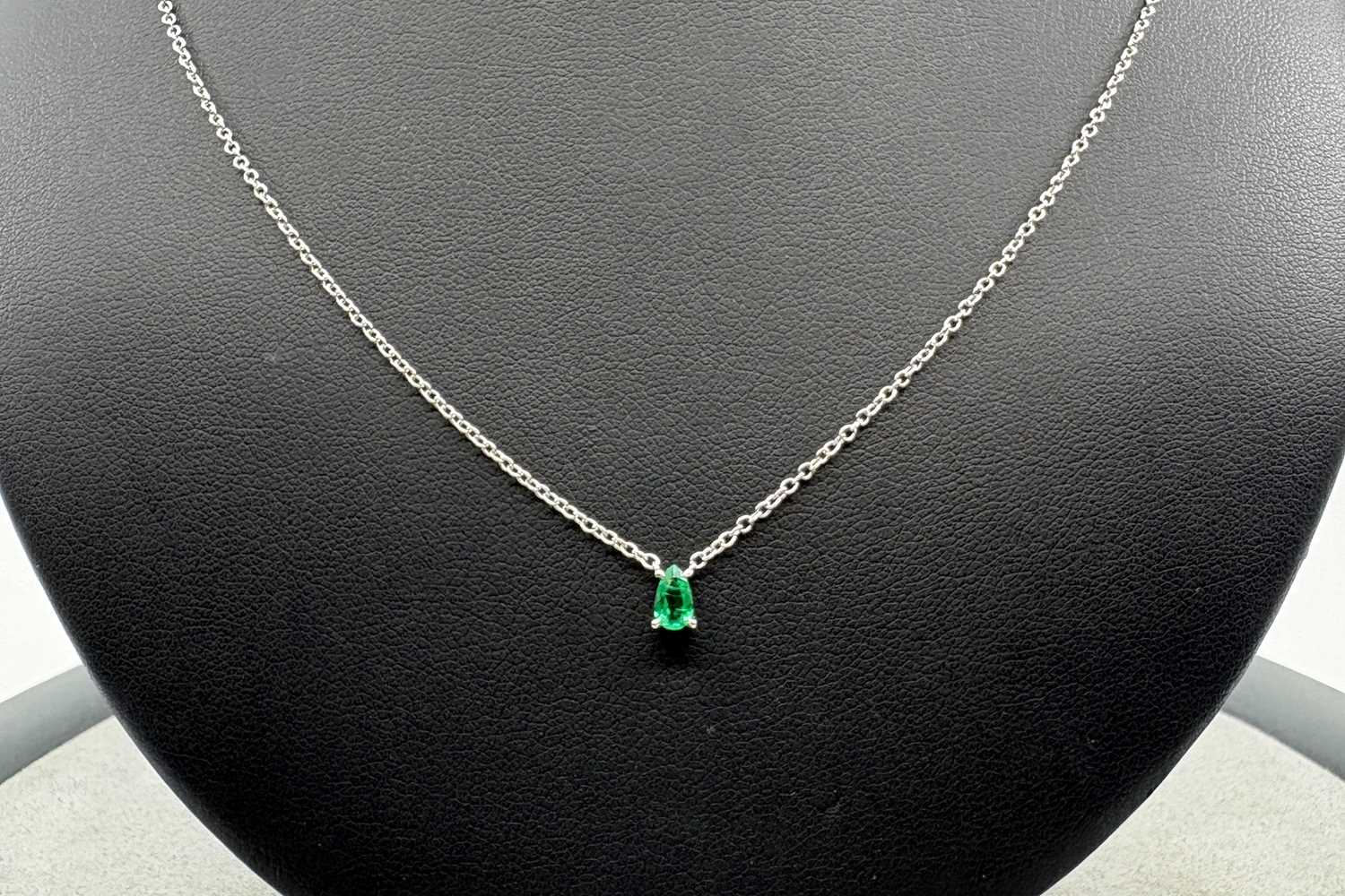 AN EMERALD SINGLE STONE PENDANT, the pear cut...
