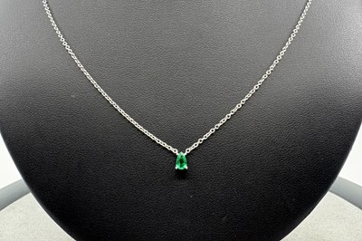 AN EMERALD SINGLE STONE PENDANT, the pear cut...