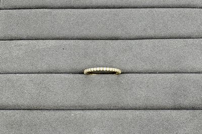 A DIAMOND HALF ETERNITY RING, the round...