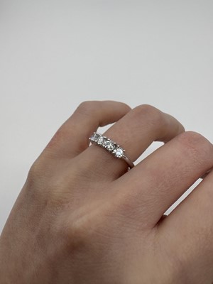 A DIAMOND FOUR STONE RING, the round brilliant...
