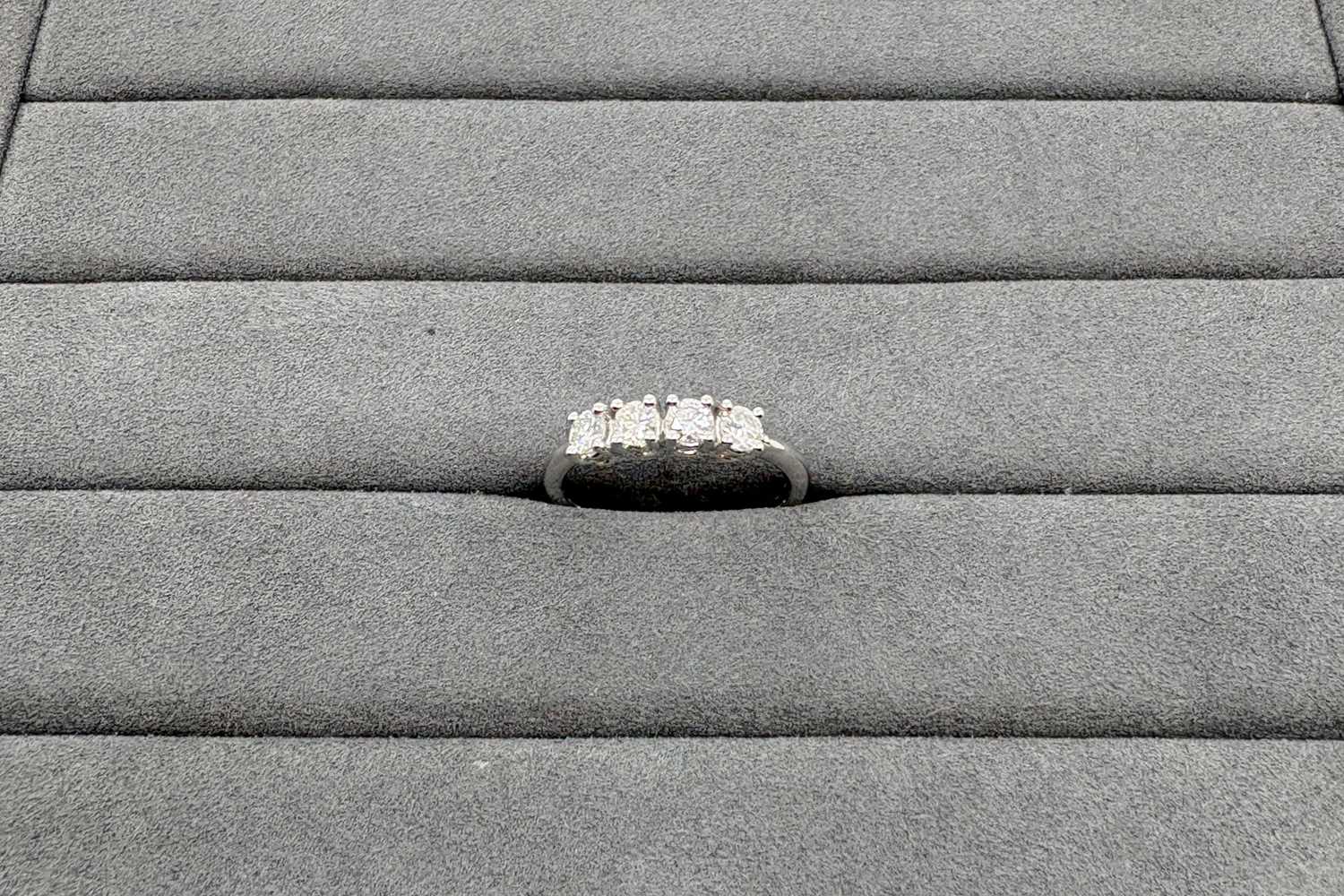 A DIAMOND FOUR STONE RING, the round brilliant...