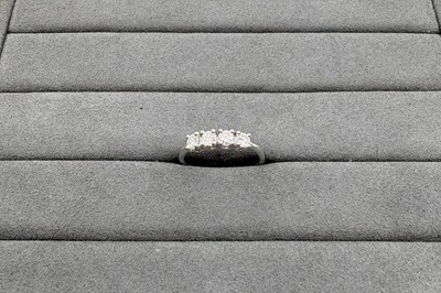 A DIAMOND FOUR STONE RING, the round brilliant...