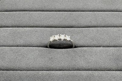 A DIAMOND FOUR STONE RING, the round brilliant...