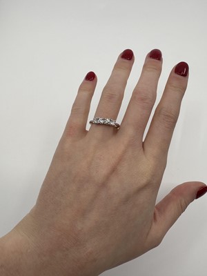 A DIAMOND FOUR STONE RING, the round brilliant...