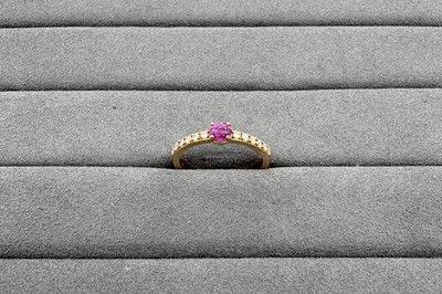 A PINK SAPPHIRE AND DIAMOND BAND RING, the...