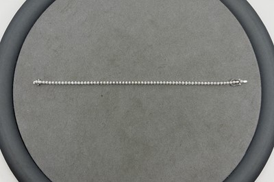 A DIAMOND LINE BRACELET, the round brilliant...