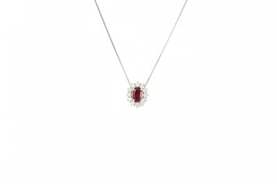 Lot 385 - A RUBY AND DIAMOND CLUSTER PENDANT, the oval...