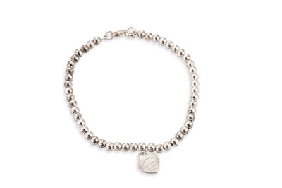 Lot 82 - A SILVER BRACELET, suspending heart shaped...