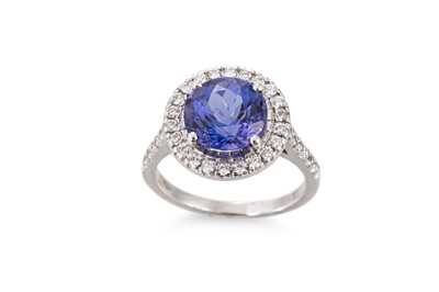 Lot 141 - A TANZANITE AND DIAMOND CLUSTER RING, the...