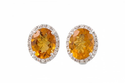 Lot 393 - A PAIR OF CITRINE AND DIAMOND EARRINGS, oval...