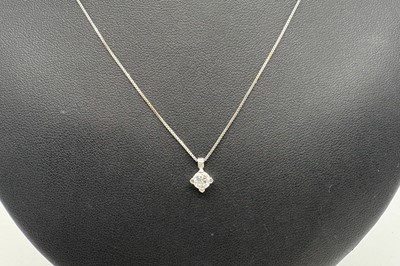 Lot 33 - A DIAMOND SOLITAIRE PENDANT, the round...