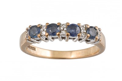 Lot 255 - A FOUR STONE SAPPHIRE RING, with diamond...
