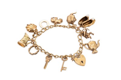 Lot 222 - A 9CT YELLOW GOLD CHARM BRACELET, with various...