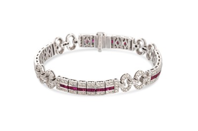 Lot 355 - A DIAMOND AND RUBY BRACELET, mounted in 18ct...