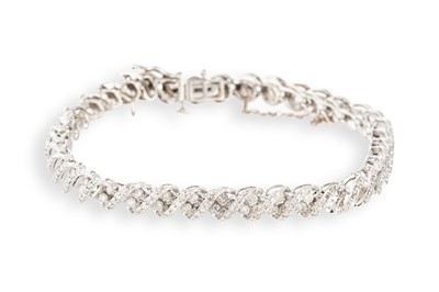 Lot 254 - A DIAMOND SET BRACELET, articulated cross-over...