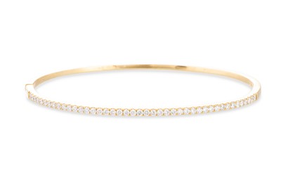 Lot 237 - A DIAMOND SET BANGLE, the round brilliant cut...
