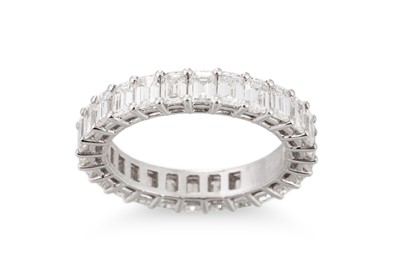 Lot 242 - A DIAMOND FULL ETERNITY RING, the emerald cut...