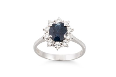 Lot 215 - A SAPPHIRE AND DIAMOND CLUSTER RING, the oval...