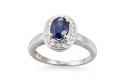 Lot 154 - A SAPPHIRE AND DIAMOND CLUSTER RING, the oval...