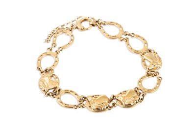 Lot 185 - A 9CT GOLD HORSE SHOE BRACELET, 16 g.